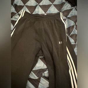 Medium sized black Adidas track pants